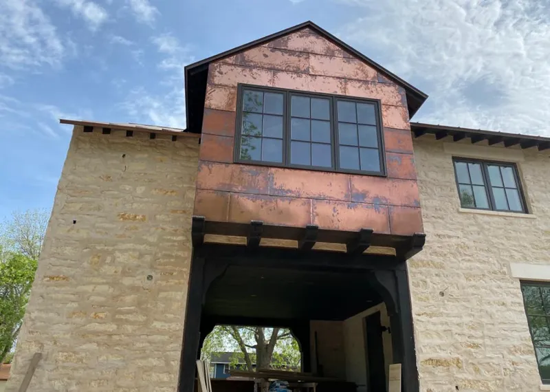 Copper metal panel facade on a stone building for Skylight Installation in Lake in the Hills