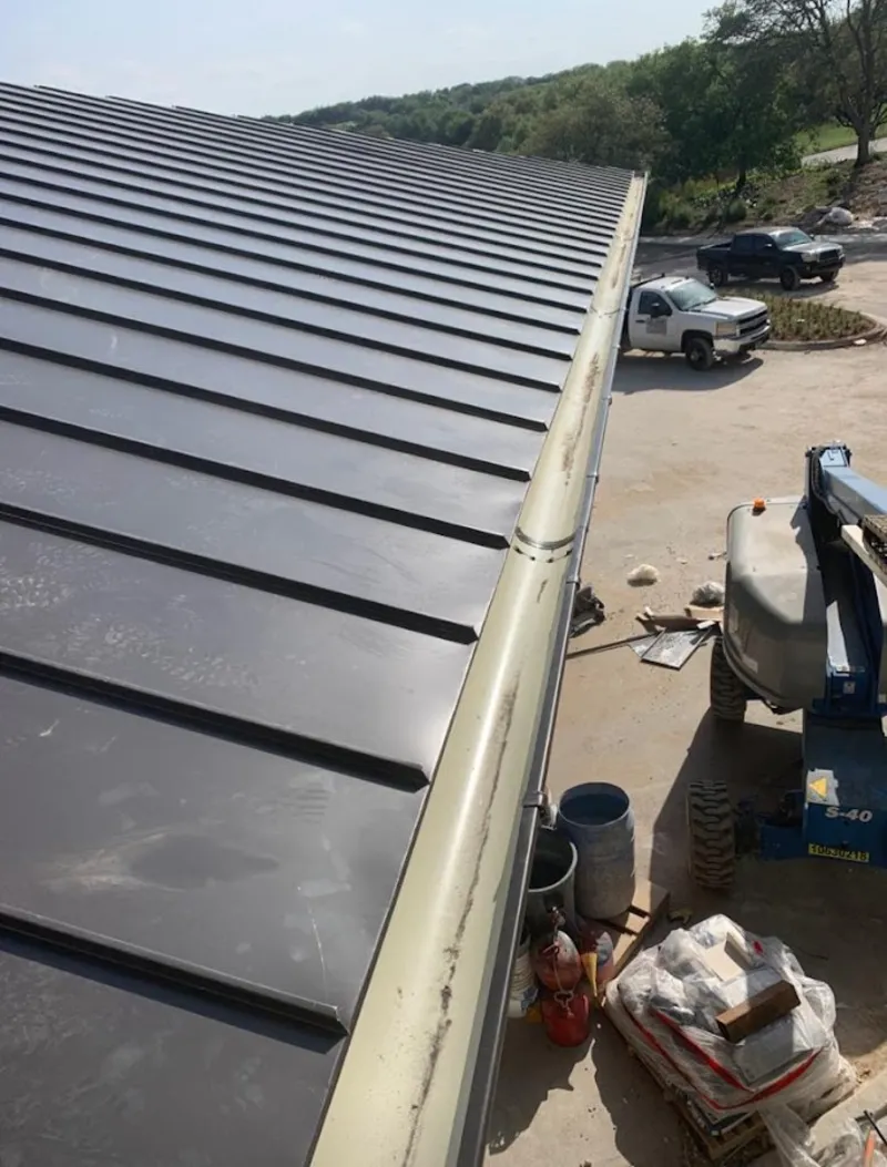 Standing seam panel and gutter detail on a metal roofing jobsite in Lake in the Hills